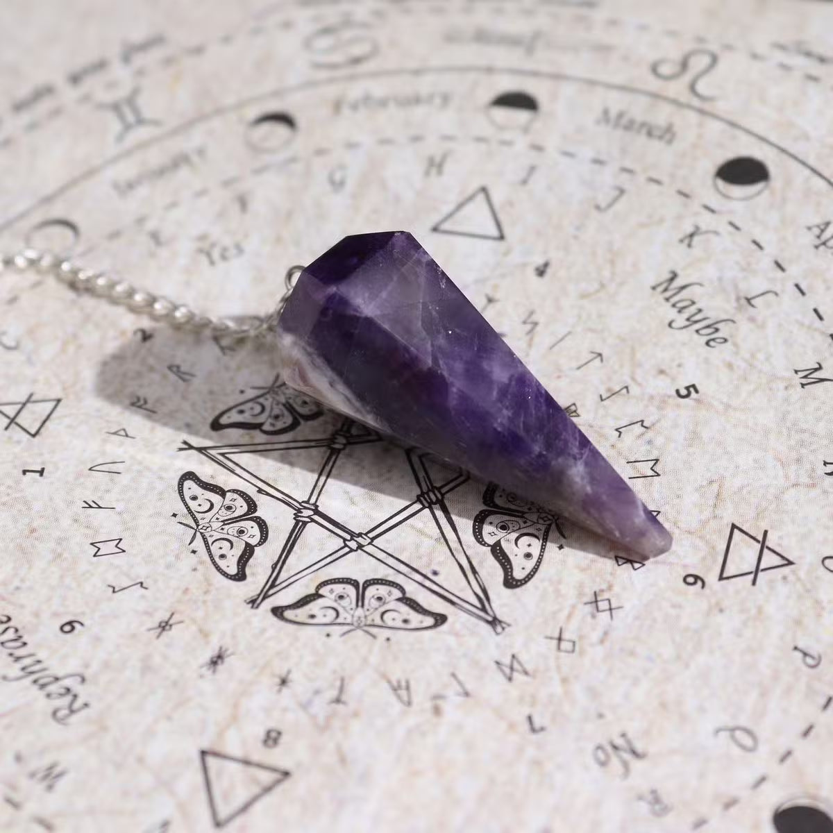 Ancient witch spell incense with Amethyst Pendulum and divination map